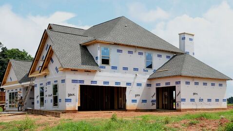 A new construction home with newly laid shingles